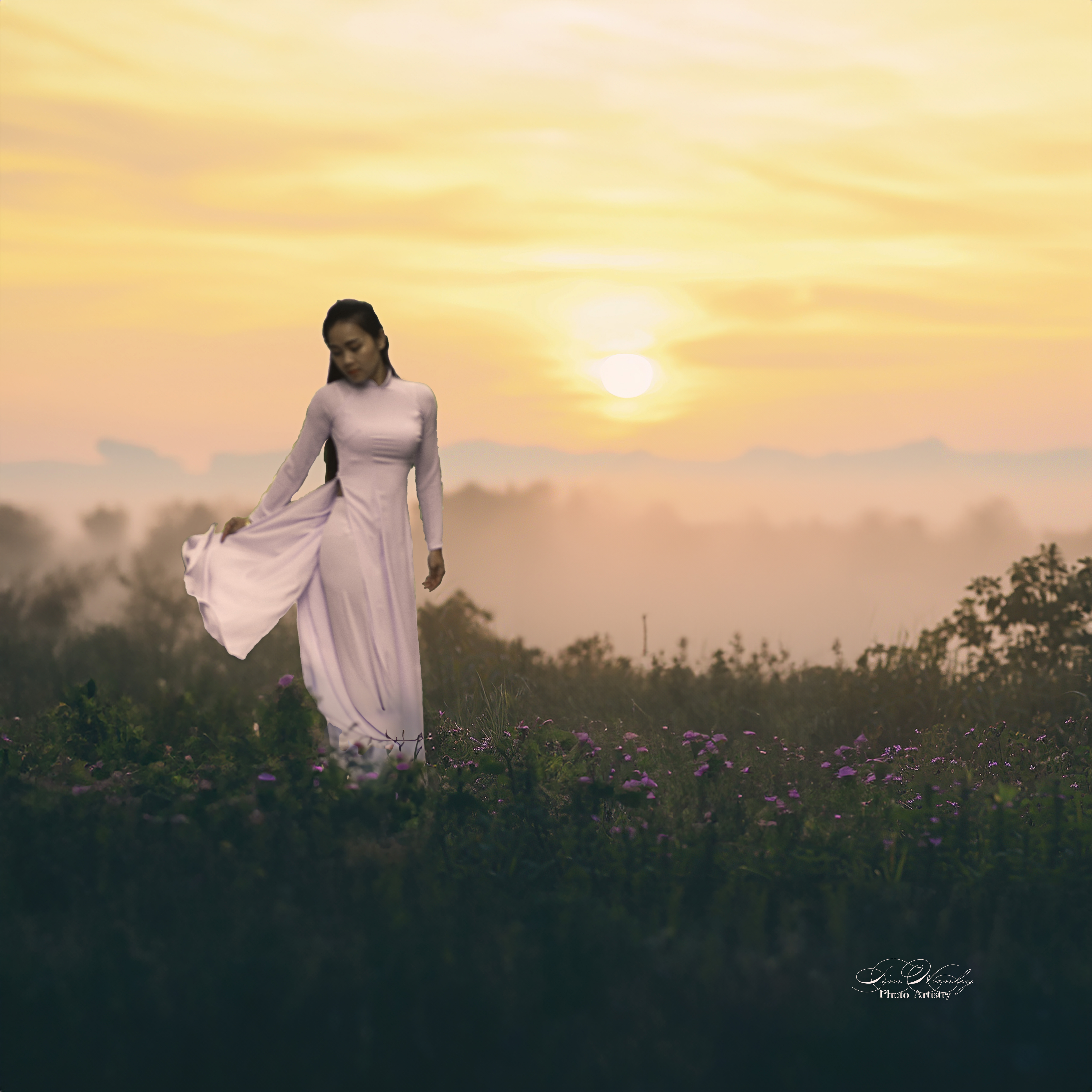 Woman walking through misty flower field at sunrise